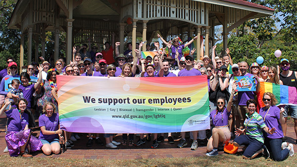 Group of people displaying support banner